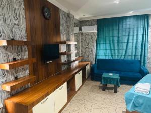 a living room with a blue couch and a television at Askar Hotel in Baku +20 photos