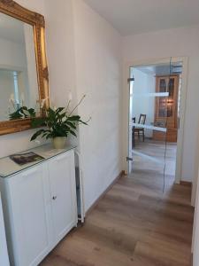 a room with a mirror and a table with a plant on it at Ferienhaus Birkelbach in Erndtebrück +30 photos