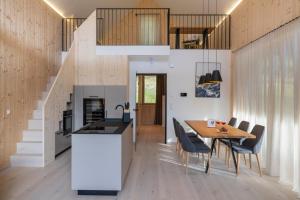 a kitchen and dining room with a table and chairs at steiRerBLiCke - Wirtsalm Chalets in Pölsen