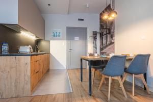 a kitchen with a table and chairs and a counter at STAYPOLSKA in Oświęcim
