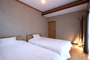 Postel nebo postele na pokoji v ubytování 奥大和ビール TAP to BED