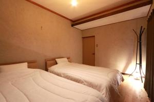 Postel nebo postele na pokoji v ubytování 奥大和ビール TAP to BED