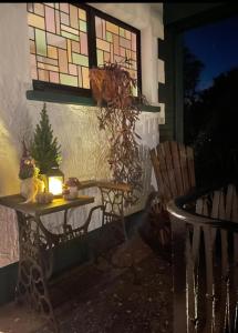 a table with a candle and a window on a house at Landhaus "Marcomagus" in Kall