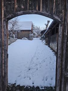 an archway in a house with snow on the ground at Casa Bunicului in Poplaca