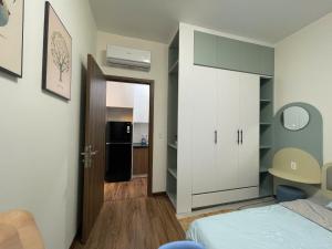 a room with a bedroom with a bed and a door at Serviced apartment- Luxcity Cẩm Phả, Quảng Ninh in Cẩm Phả