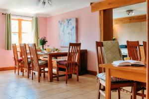 a dining room with a table and chairs at Finest Retreats - The Welsh Farmhouse in Aberystwyth