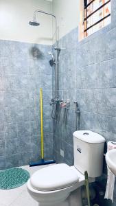a bathroom with a shower and a toilet and a sink at Lake View Muyenga Apartment in Kampala