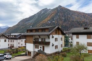 a group of buildings in front of a mountain at Dolomites Apartment Finestra sul Civetta in Alleghe