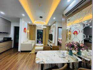a living room with a dining table and a living room at Serviced apartment- Luxcity Cẩm Phả, Quảng Ninh in Cẩm Phả