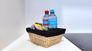 a basket with two bottles of water and chips at Le Cocon Studio in Brussels