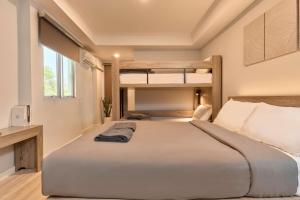 a bedroom with a large bed and bunk beds at Thapae60 Mini Hotel in Chiang Mai