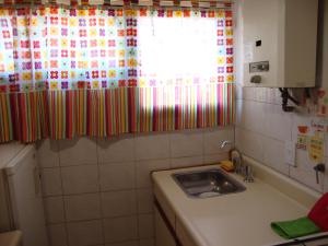 a small kitchen with a sink and a window at Departamento Maipu Cordoba in Córdoba