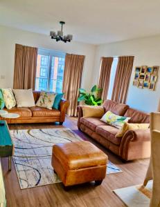 a living room with two couches and a rug at The Mirrored House in Kent