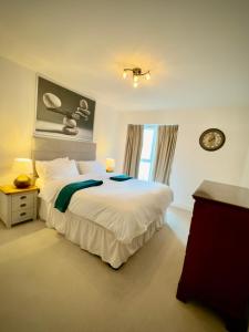 a bedroom with a large white bed and a window at The Mirrored House in Kent