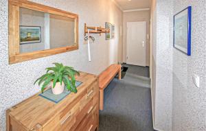 a room with a wooden dresser with a plant on it at Ferienwohnung Peenemünde in Peenemünde