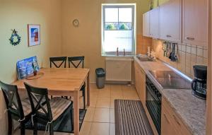 a kitchen with a wooden table and a sink at Ferienwohnung Peenemünde in Peenemünde