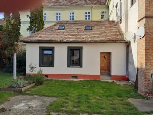 a small white house with a brown roof at Varkor Villa at the castle in Kőszeg