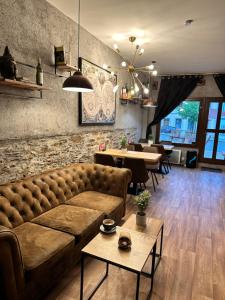 a living room with a couch and tables and chairs at Horský dům in Jáchymov