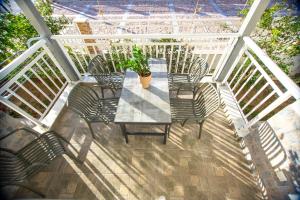 a table with chairs and a potted plant on a patio at House Kohili in Nea Vrasna