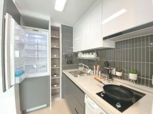a kitchen with a sink and a refrigerator at House of Hyuni in Busan
