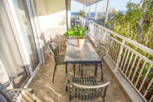 a balcony with a table and chairs on a balcony at House Kohili in Nea Vrasna