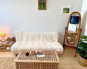 a living room with a couch and a table at House of Hyuni in Busan
