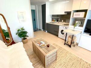 a kitchen with a couch and a table in a room at House of Hyuni in Busan