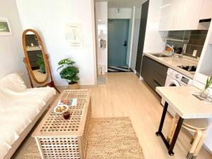 a living room with a couch and a table at House of Hyuni in Busan