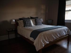 a bed with pillows on it in a bedroom at Forgo tten Paddock in Maitland