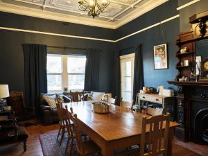 a dining room with a wooden table and chairs at Forgo tten Paddock in Maitland