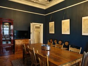 a dining room with a wooden table and chairs at Forgo tten Paddock in Maitland