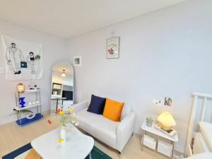 a living room with a white couch and a table at House of Hyuni in Busan