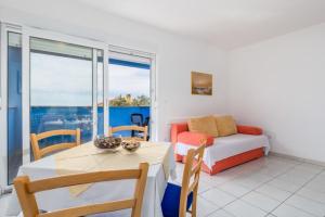 a bedroom with a bed and a table and a table and chairs at Apartments Cathy in Mandre