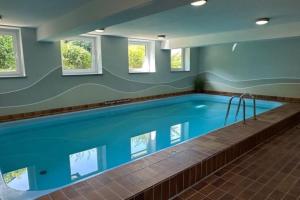 a large swimming pool in a building at Ferienbutze Harz Drachenperle in Bad Lauterberg