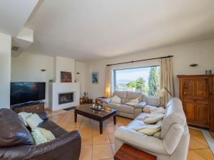 a living room with two couches and a tv at Cubo's Villa Las Capuchinas in Torremolinos
