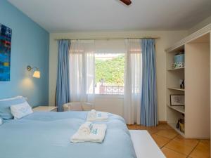 a bedroom with two beds with towels on them at Cubo's Villa Las Capuchinas in Torremolinos +65 photos