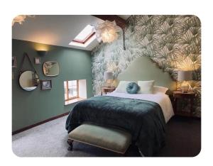 a bedroom with a large bed with a leafy wall at The Coach House in Berriew