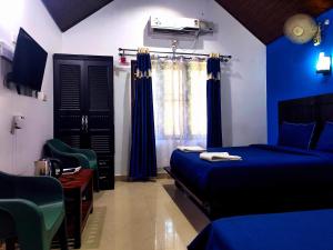 Postel nebo postele na pokoji v ubytování The Twin Cottages Coorg