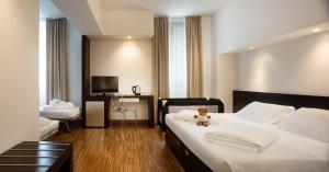a bedroom with a bed with a teddy bear on it at Astoria Resort in Riva del Garda
