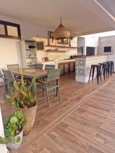 a kitchen and dining room with a table and chairs at appartement cosy in Somone