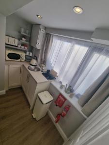 a small kitchen with a sink and a window at Castle Ings jem in Knaresborough