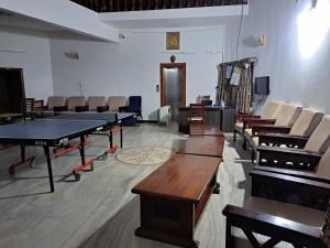 a room with a ping pong table and chairs at COASTAL GRAND MAHENDRAVANAM - KOLLI HILLS in Kolli Hills