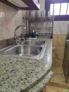 a kitchen counter with a stainless steel sink at Where landsacpe view meets Luxury in Cairo