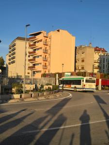 a shadow of a bus driving down a street with buildings at MMM HOME Train Station 3 in Mestre