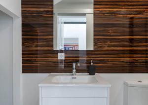 a bathroom with a sink and a mirror at Chic Loft with Garden, Sleeps 4 in Porto +28 photos