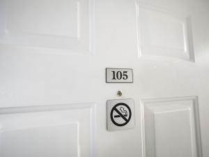 a white door with a no smoking sign on it at 105 Pointes North Inn in Charlevoix +6 photos