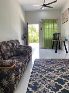 a living room with a couch and a table at inap desa batu buruk 2 in Kuala Terengganu