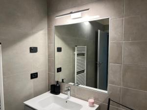 a bathroom with a sink and a large mirror at Stelle di Verona - Selene in Verona +39 photos