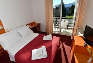 Posteľ alebo postele v izbe v ubytovaní Hotel Alkar