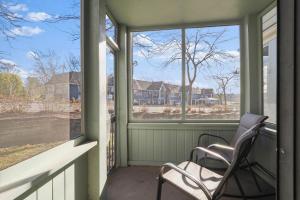 a porch with a chair and two windows at 107 Pointes North Inn in Charlevoix